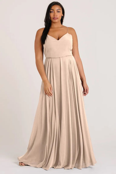 Woman in a flowing beige Inesse chiffon bridesmaid dress by Jenny Yoo at Bergamot Bridal.