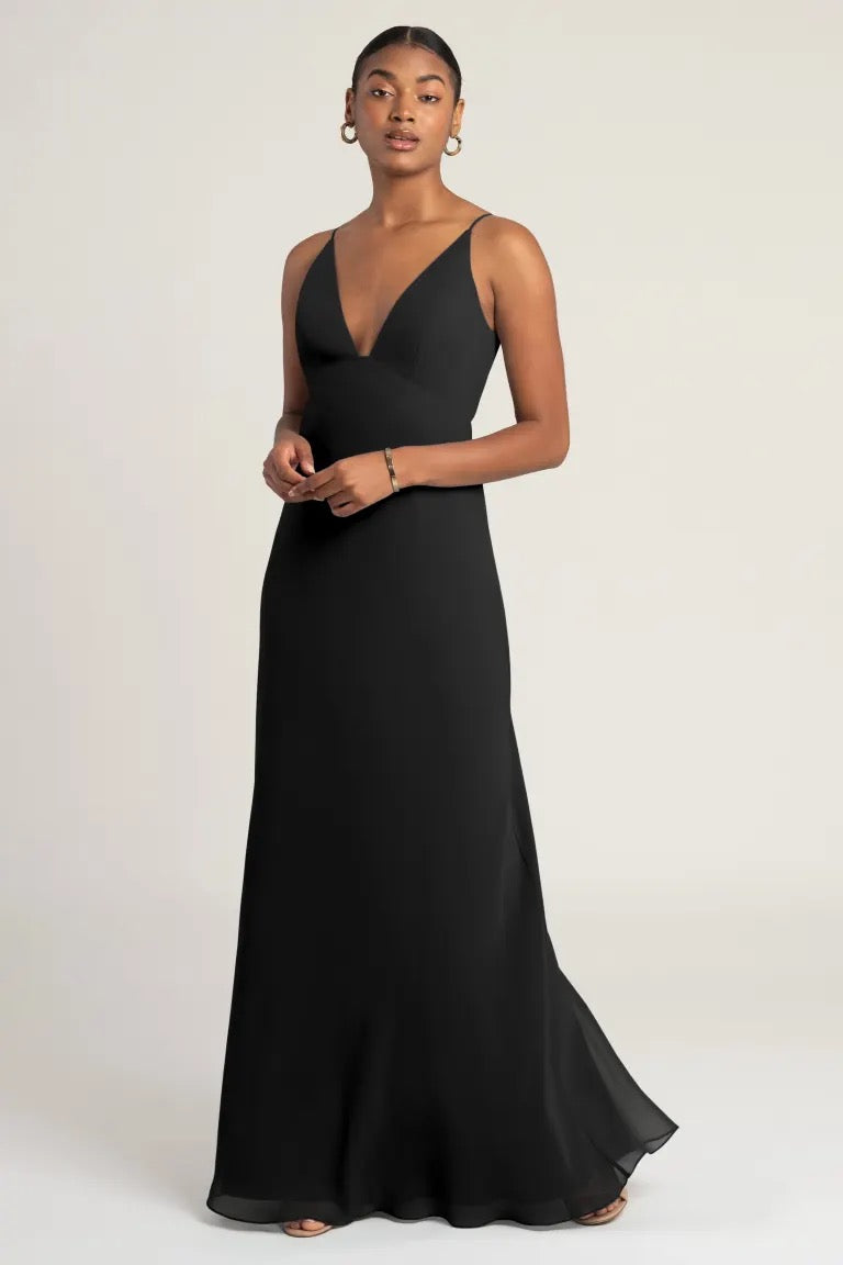 Woman posing in elegant black evening gown with an empire waist - Jude bridesmaid dress by Jenny Yoo from Bergamot Bridal.