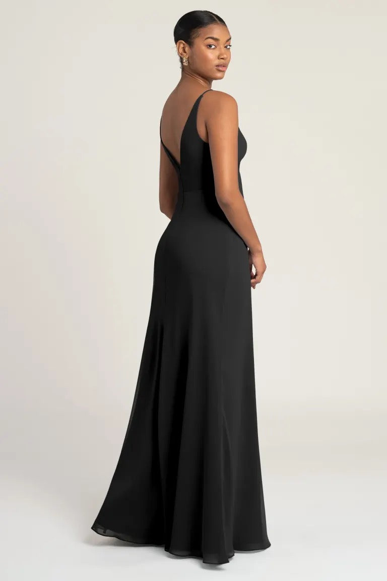 Woman in a Jude bridesmaid dress by Jenny Yoo from Bergamot Bridal, with an empire waist, posing over a neutral background.