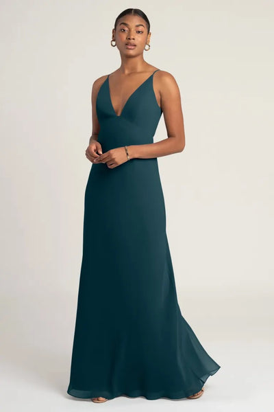 A woman in an elegant Jude - Bridesmaid Dress by Jenny Yoo posing against a neutral background.