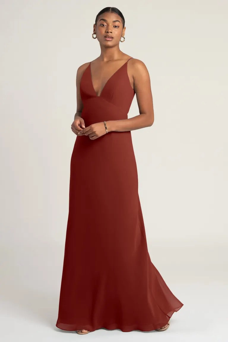 Woman posing in an elegant Jude - Bridesmaid Dress with a notched neckline by Bergamot Bridal.