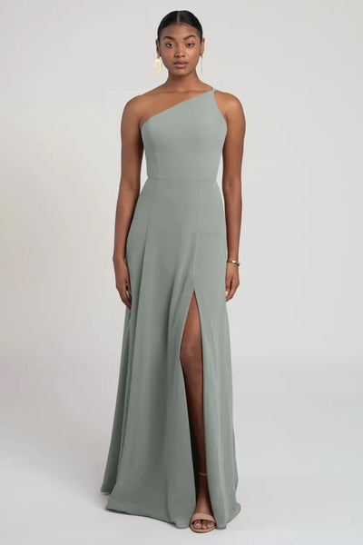 Woman in a one-shoulder chiffon bridesmaid dress with a thigh-high slit, the Kora - Jenny Yoo Bridesmaid Dress from Bergamot Bridal.