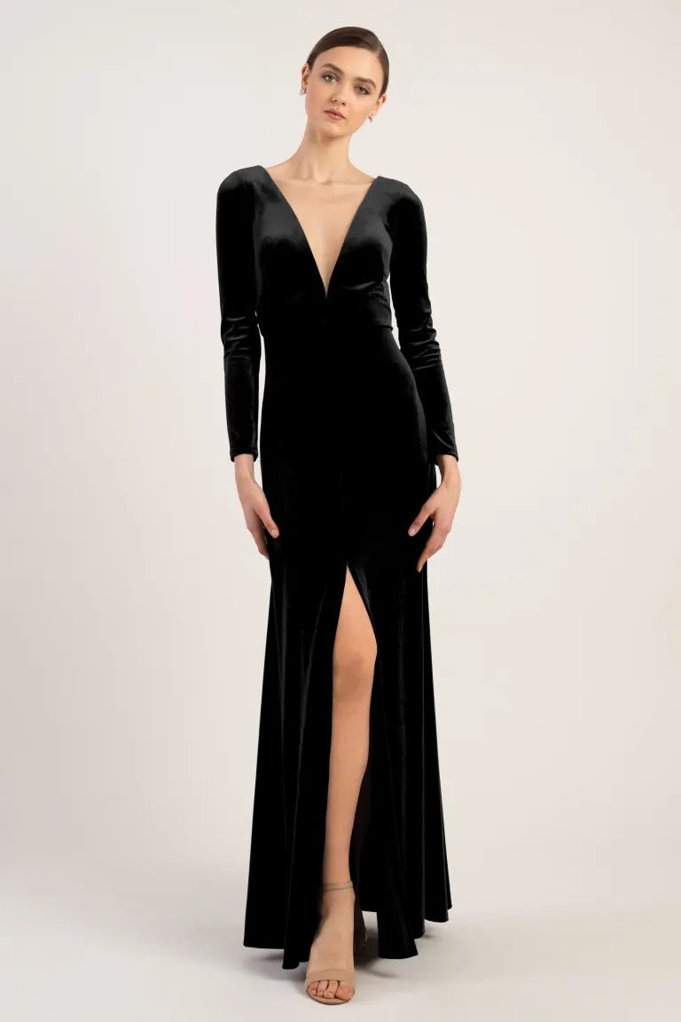 Woman in an elegant Malia - Bridesmaid Dress by Jenny Yoo with a thigh-high slit and an A-line silhouette from Bergamot Bridal.
