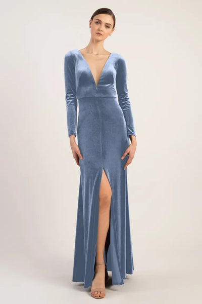 Woman posing in a Luxe Velvet Malia - Bridesmaid Dress by Jenny Yoo with a slit from Bergamot Bridal.