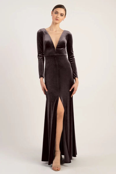 Malia modeling an elegant bridesmaid dress, a Bridesmaid Dress by Jenny Yoo with a Luxe Velvet long-sleeve gown with a v-neckline and thigh-high slit from Bergamot Bridal.