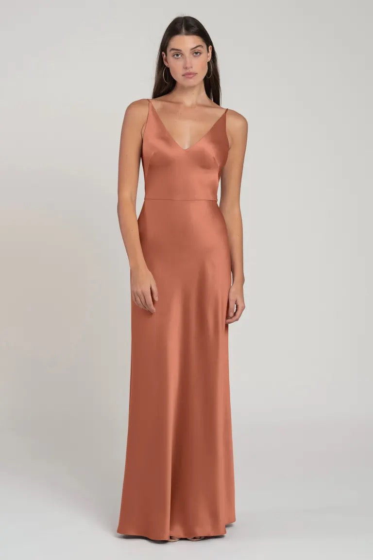 Woman wearing a long, sleeveless Marla - Bridesmaid Dress by Jenny Yoo evening dress with a V-neck from Bergamot Bridal.