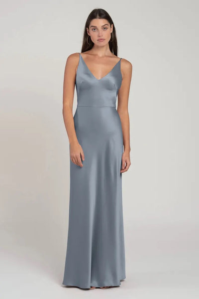 Woman wearing a sleek, slate gray satin bridesmaid dress with spaghetti straps. 
Product: Marla - Bridesmaid Dress by Jenny Yoo
Brand Name: Bergamot Bridal