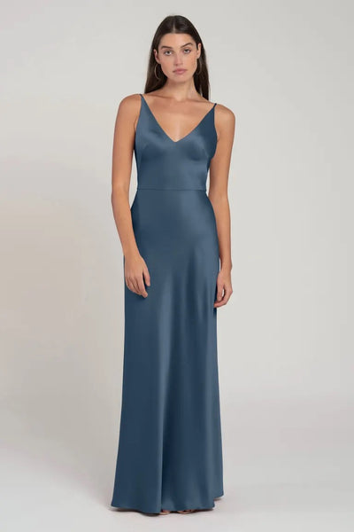 Woman posing in a sleek Marla - Bridesmaid Dress by Jenny Yoo with a bias-cut skirt from Bergamot Bridal.