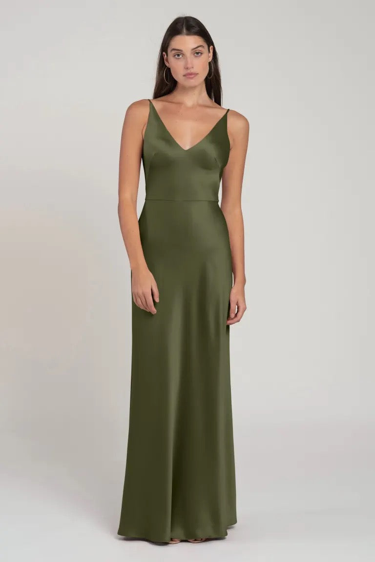 Woman modeling an Marla olive green satin bridesmaid dress with spaghetti straps by Jenny Yoo from Bergamot Bridal.