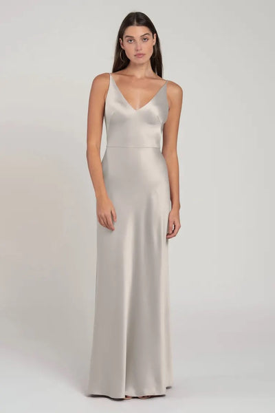 Woman posing in a sleek, sleeveless Marla bridesmaid dress by Jenny Yoo with a V-neck from Bergamot Bridal.