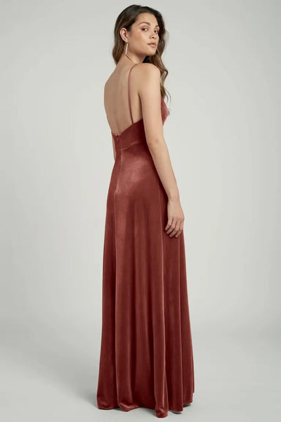 Woman in an elegant Melanie velvet gown with a V neck, viewed from the back by Jenny Yoo from Bergamot Bridal.