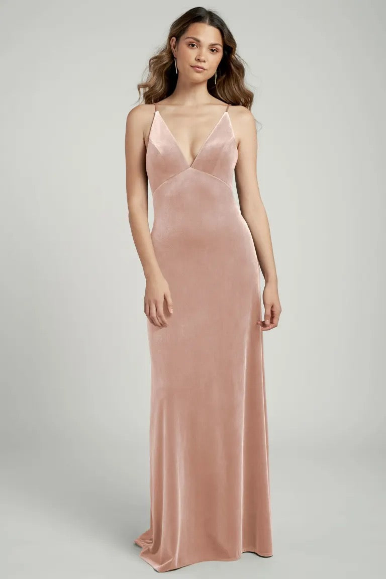 Woman in an elegant pink satin slip dress, the Melanie - Bridesmaid Dress by Jenny Yoo from Bergamot Bridal.