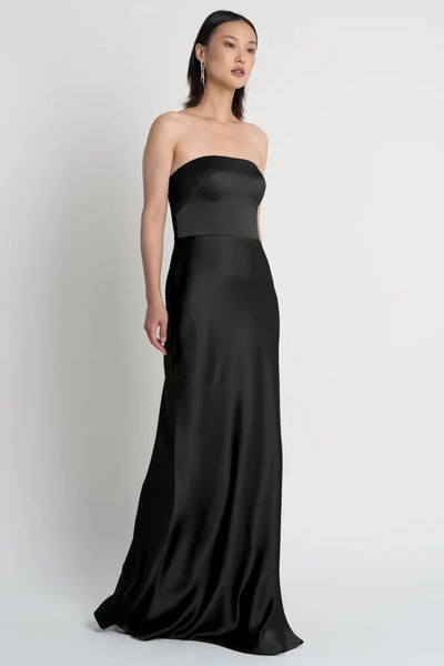 Woman in a strapless black Melody bridesmaid dress by Jenny Yoo with a bias-cut skirt from Bergamot Bridal.