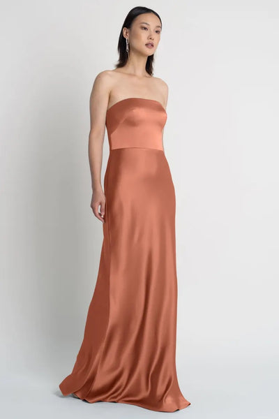 Woman in an elegant Melody - Bridesmaid Dress by Jenny Yoo with a bias-cut skirt from Bergamot Bridal.