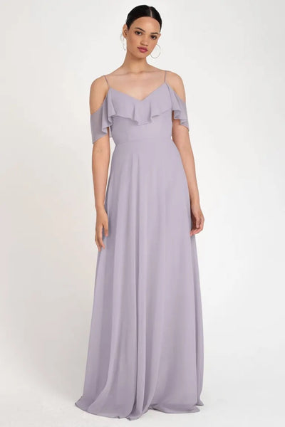 Woman in an elegant lavender evening gown with an off-the-shoulder neckline, wearing the Mila - Bridesmaid Dress by Jenny Yoo from Bergamot Bridal.