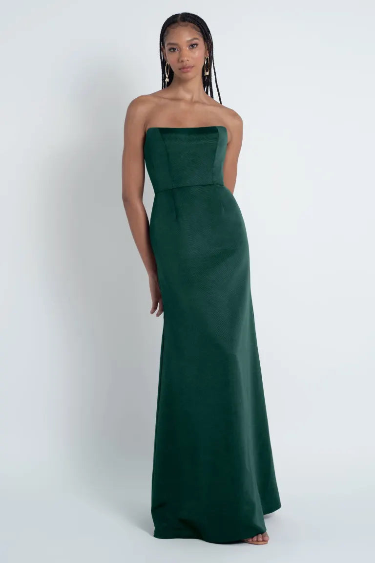 A woman in an elegant green Paige - Jenny Yoo Bridesmaid Dress gown posing against a neutral background.