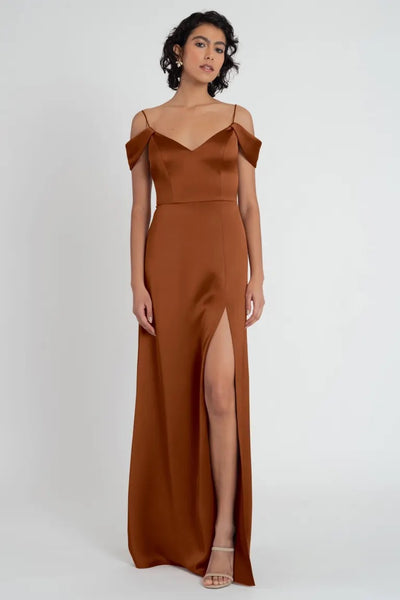 Woman in an elegant brown satin evening dress with a thigh-high slit, wearing the Priyanka - Bridesmaid Dress by Jenny Yoo from Bergamot Bridal.
