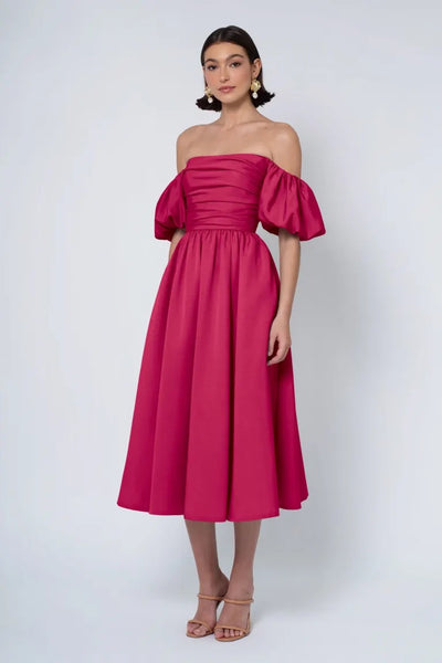 Woman in an elegant Regina - Jenny Yoo Bridesmaid Dress standing against a plain background.