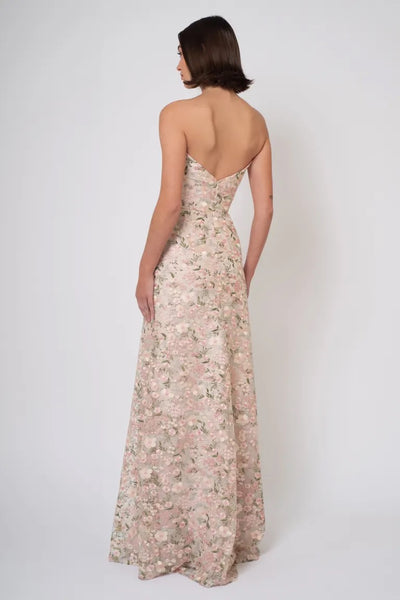 A woman seen from behind, wearing a strapless floral evening gown with Ophelia embroidery. - Reina - Jenny Yoo Bridesmaid Dress by Bergamot Bridal.