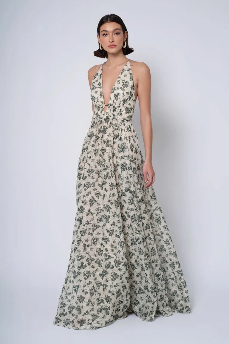 Woman modeling a Robin - Jenny Yoo Bridesmaid Dress in chiffon wildflowers print with a halter neckline and deep v-neckline by Bergamot Bridal.