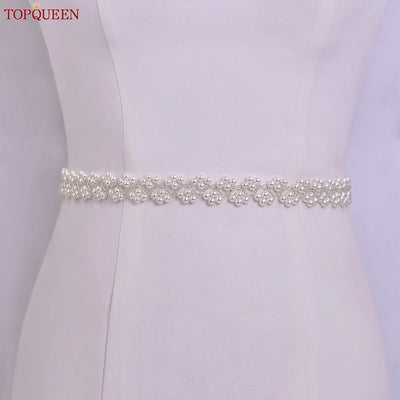 A white dress with an added detail of the Pearl and Glass Beaded Bridal Belt by TopQueenOfficial, perfect for a bride.