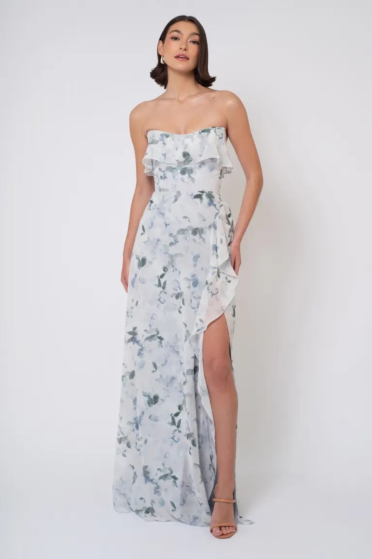 Woman posing in a Salma Print - Jenny Yoo Bridesmaid Dress with a side slit from Bergamot Bridal.