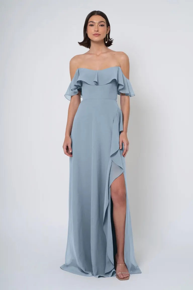 Woman in an elegant light blue Jenny Yoo Bridesmaid Dress with a side slit from Bergamot Bridal.