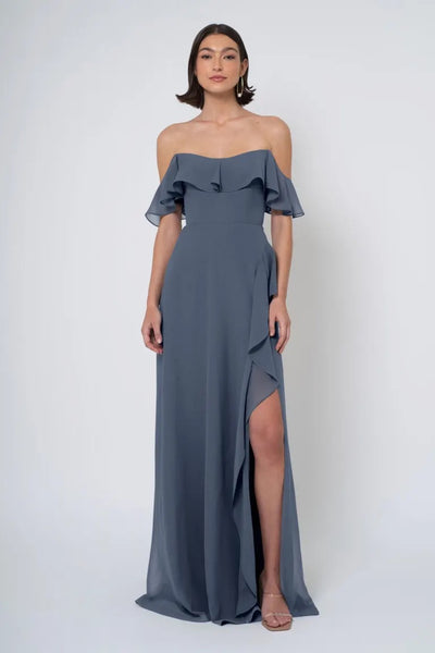 Woman in an elegant Jenny Yoo Bridesmaid Dress with an off-the-shoulder neckline and a thigh-high side slit from Bergamot Bridal.