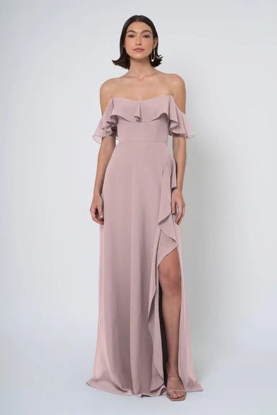 Woman in an elegant Jenny Yoo Bridesmaid Dress, off-the-shoulder gown with ruffle detailing and a high side slit from Bergamot Bridal.