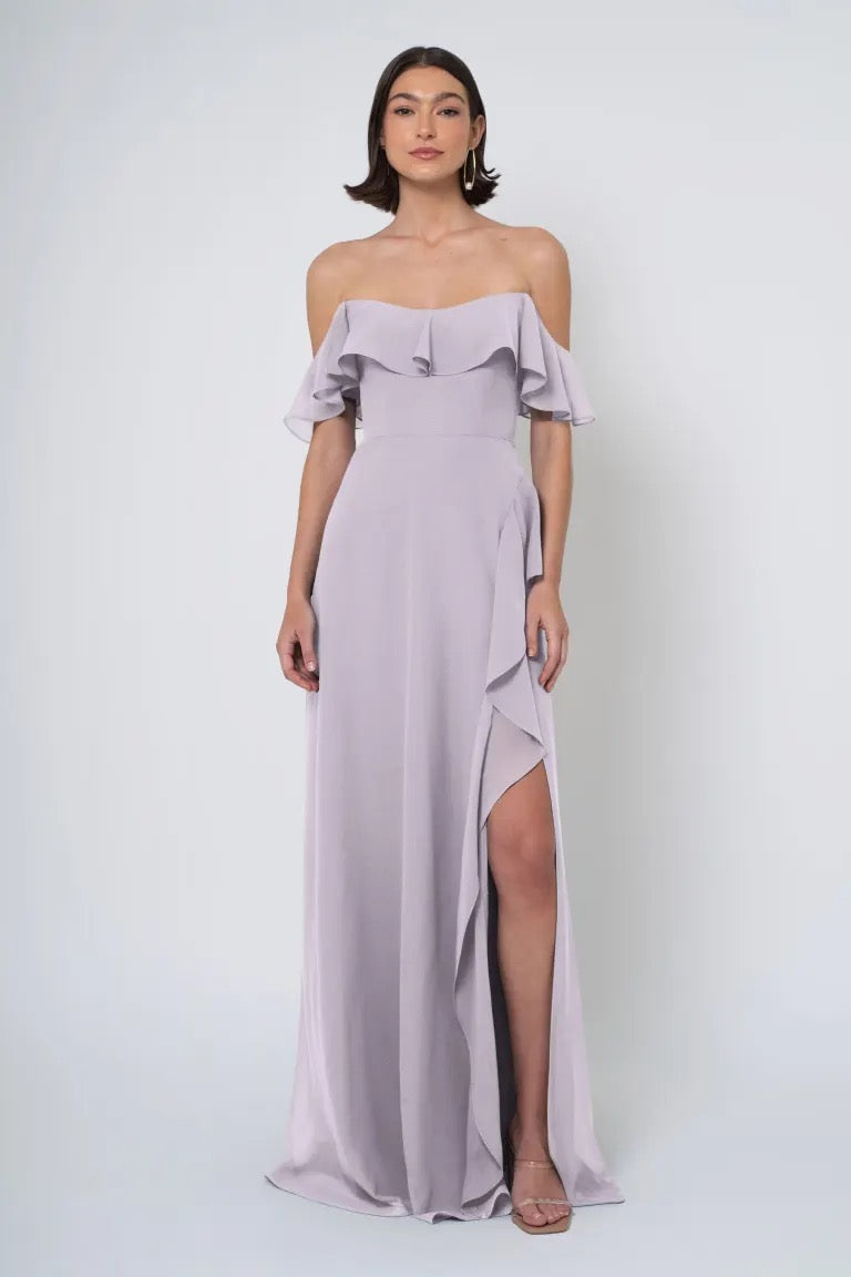 Woman in an elegant lavender Salma - Jenny Yoo Bridesmaid dress with a side slit from Bergamot Bridal.