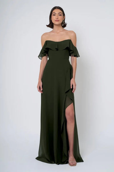 Woman in an elegant green Jenny Yoo Bridesmaid Dress with a side slit from Bergamot Bridal.