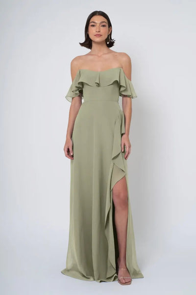 Woman in an olive green off-the-shoulder neckline Salma gown by Jenny Yoo Bridesmaid Dress with a side slit from Bergamot Bridal.