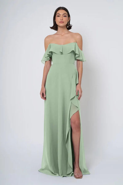 Woman in an elegant Jenny Yoo Bridesmaid Dress with a ruffled neckline and a high side slit, from Bergamot Bridal.