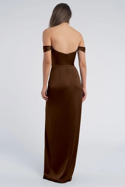A woman is seen from the back wearing an off-the-shoulder Sawyer - Bridesmaid Dress by Jenny Yoo evening gown from Bergamot Bridal.