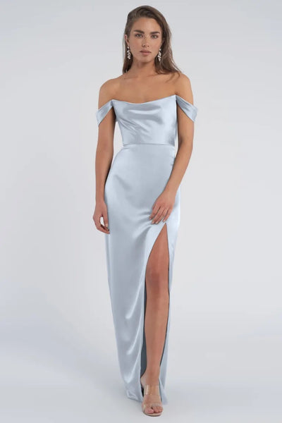 A woman wearing an off-the-shoulder Jenny Yoo Sawyer bridesmaid dress with a thigh-high slit from Bergamot Bridal.