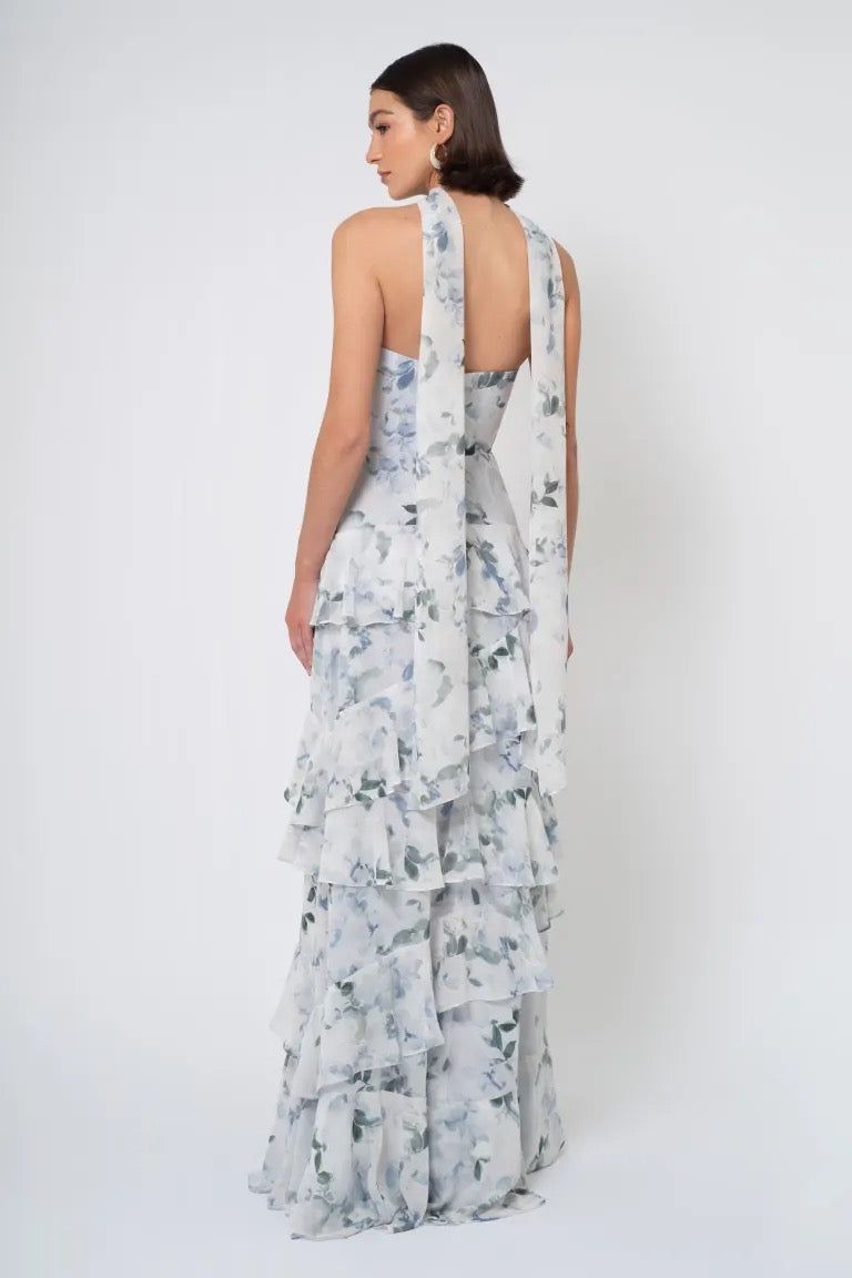 Woman wearing a strapless Simona Print - Jenny Yoo bridesmaid dress with cascading layers and a low back from Bergamot Bridal.