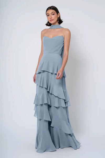 Woman posing in a pale blue strapless cowl neckline tiered Simona - Jenny Yoo Bridesmaid Dress by Bergamot Bridal.