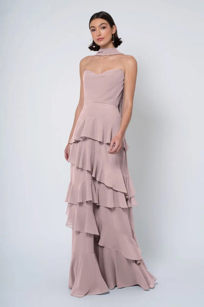 Woman in an elegant Jenny Yoo Bridesmaid Dress with a strapless cowl neckline, posing against a plain background.