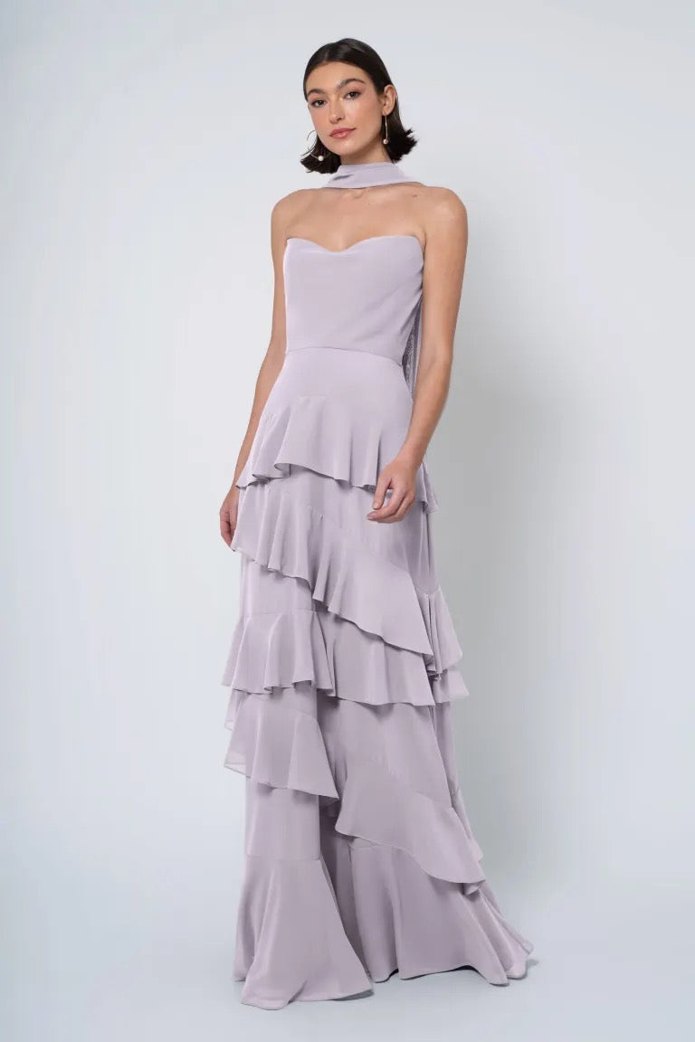 A woman modeling a strapless cowl neckline Jenny Yoo Bridesmaid Dress in a light purple color at Bergamot Bridal.