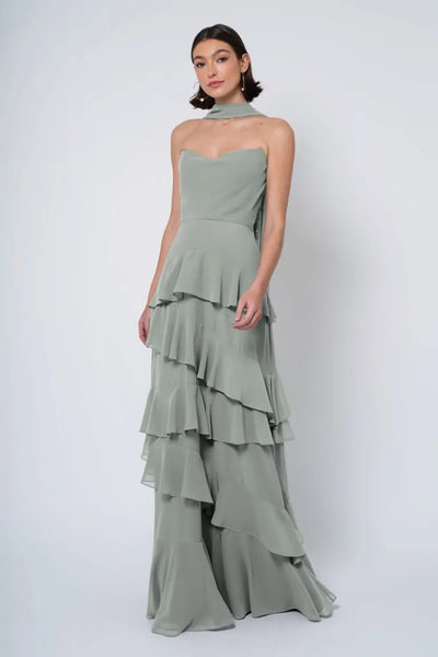 A woman models an elegant sage green strapless cowl neckline Simona - Jenny Yoo Bridesmaid Dress gown from Bergamot Bridal.