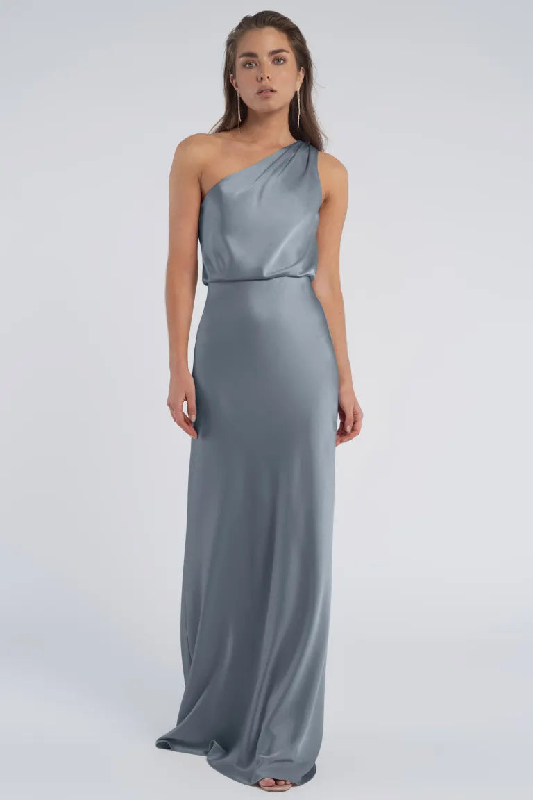 Woman in an elegant Sterling - Jenny Yoo Bridesmaid gown with a one-shoulder neckline from Bergamot Bridal.