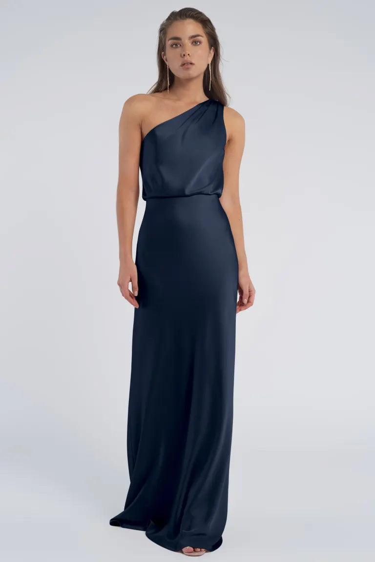Woman in an elegant luxe satin fabric, one-shoulder navy blue evening gown - Sterling by Bergamot Bridal