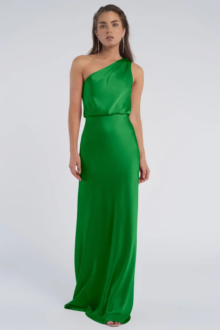 A woman in a Jenny Yoo Bridesmaid dress featuring a one-shoulder neckline made of luxe satin fabric from Bergamot Bridal.