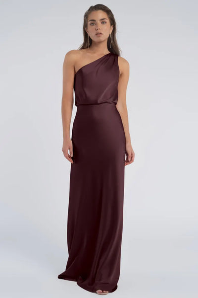 Woman wearing a Jenny Yoo Bridesmaid dress in luxe satin fabric with a one-shoulder neckline from Bergamot Bridal.