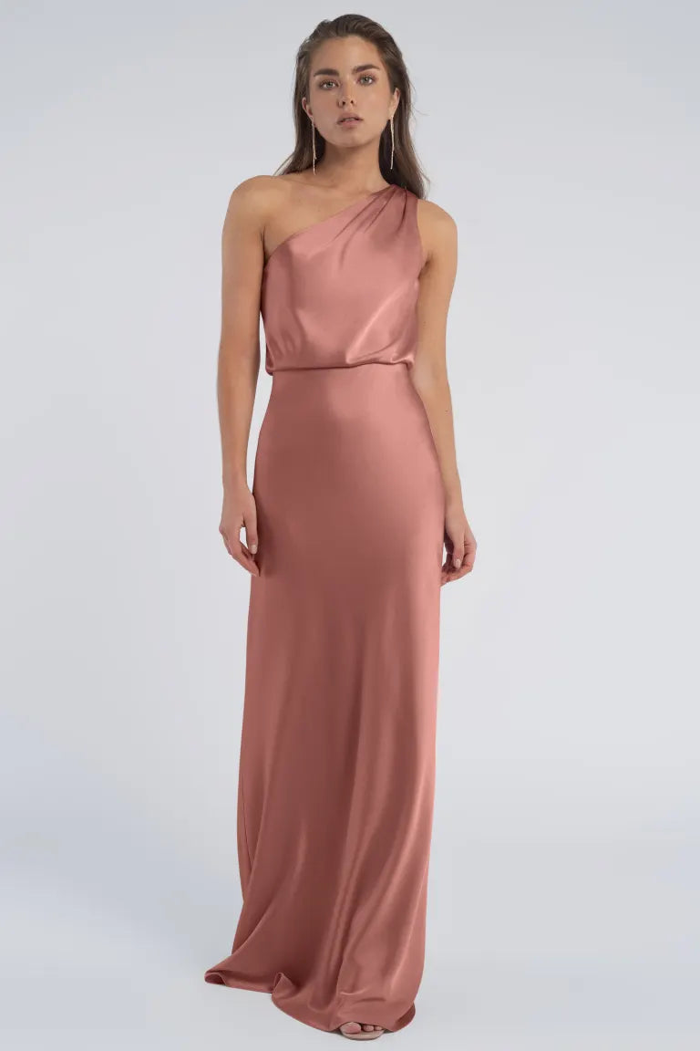 Woman in an elegant Jenny Yoo Bridesmaid pink one-shoulder dress with a luxe satin fabric from Bergamot Bridal.