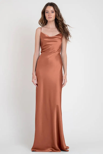 Woman in an elegant terracotta Sylvie - Bridesmaid Dress by Jenny Yoo, reminiscent of Old Hollywood from Bergamot Bridal.