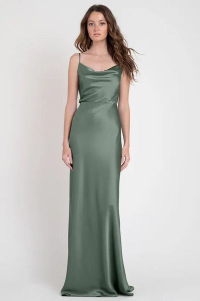 Woman in a Sylvie - Bridesmaid Dress by Jenny Yoo from Bergamot Bridal, an Old Hollywood sleek green satin evening gown.