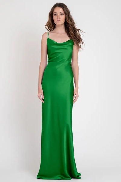 A woman wearing a stylish green satin slip evening dress. 
Sylvie - Bridesmaid Dress by Jenny Yoo from Bergamot Bridal.