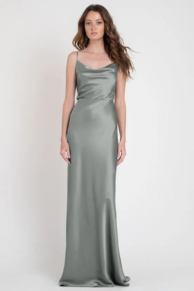 Woman modeling a sleek, one-shoulder Sylvie Bridesmaid Dress by Jenny Yoo reminiscent of Old Hollywood glamour from Bergamot Bridal.