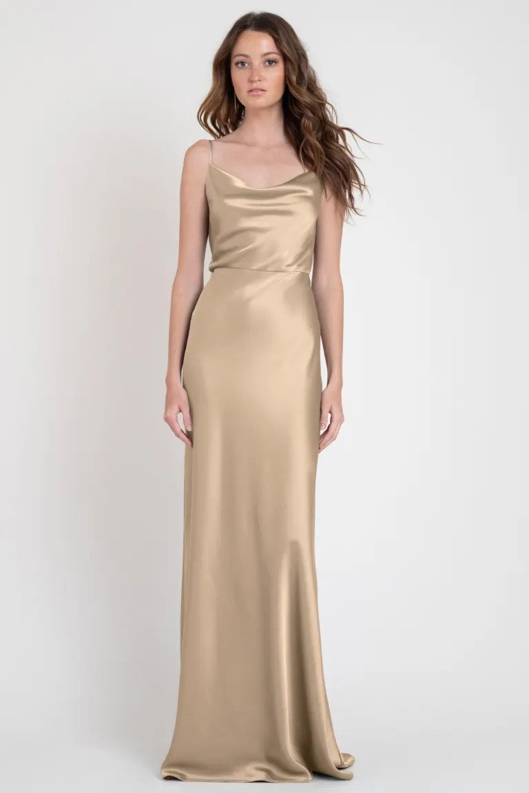 Woman in a show-stopping Sylvie - Bridesmaid Dress by Jenny Yoo, standing against a neutral background.